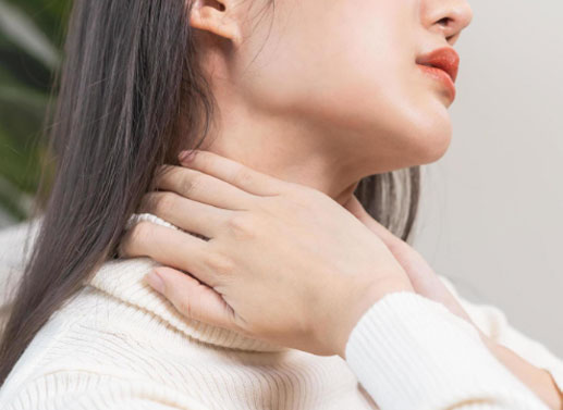 a person rubbing on the sides of their strained neck